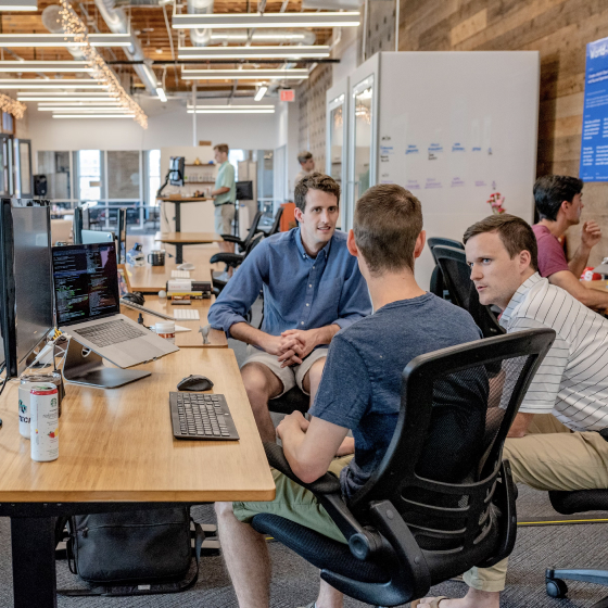 Voice Metrics team collaborating in a modern office environment